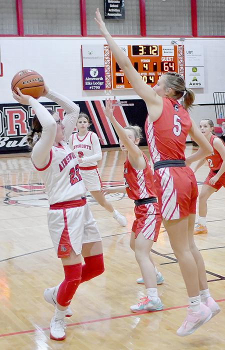 Broken Bow’s Jaycee Staples goes up to prevent Gracyn Painter from taking a shot.