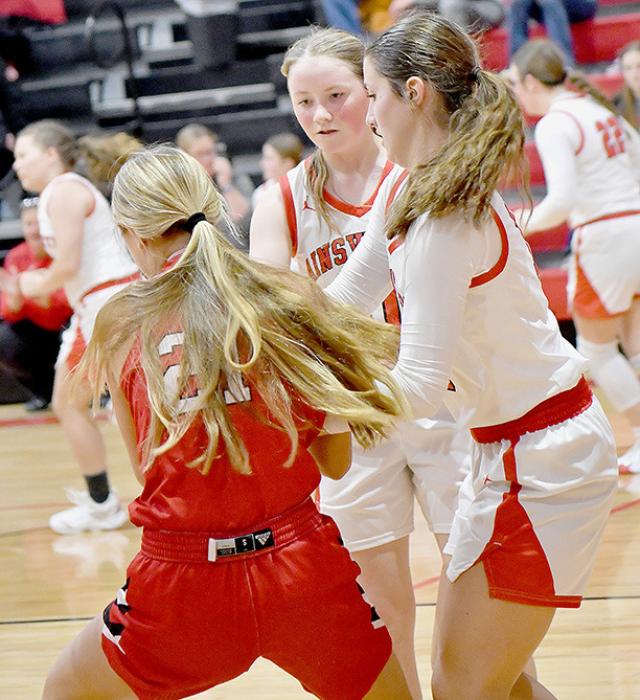 Kenley Welke and Willa Flynn fight with Ord’s Elle Jess for a rebound.