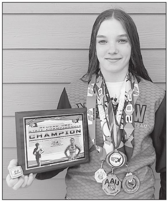 An advocate for girls wrestling in Nebraska, Jolyn Pozehl of Long Pine displays her many awards from this year’s wrestling tournaments.
