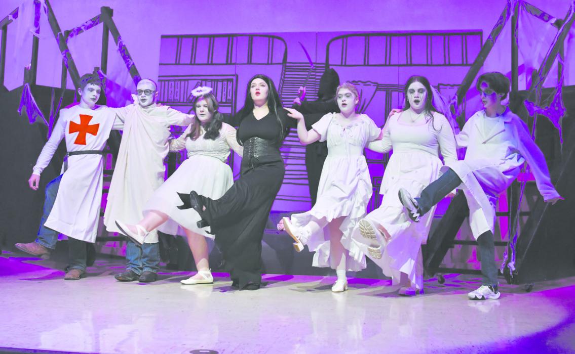 The ancestors join Morticia Addams for a kick line. The cast members above are (left to right): Mason Winters, Ty Bolli, Alyla Stamp, Madison Phares, Cassie Cole, Miranda Phares, and Diego Godoy.