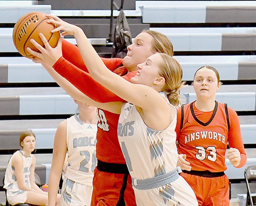 Jocelyn Good and Preslie Robertson fight for control of a rebound. Referees called it a jump ball and Ainsworth got the ball.