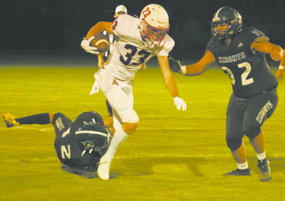 Jacob Ortner runs the ball down the field, trying to avoid being tackled by Sandhills-Thedford’s Mason Cooksley (32) and Brandon Goshorn (12). Photo Courtesy of Aiden Rowley