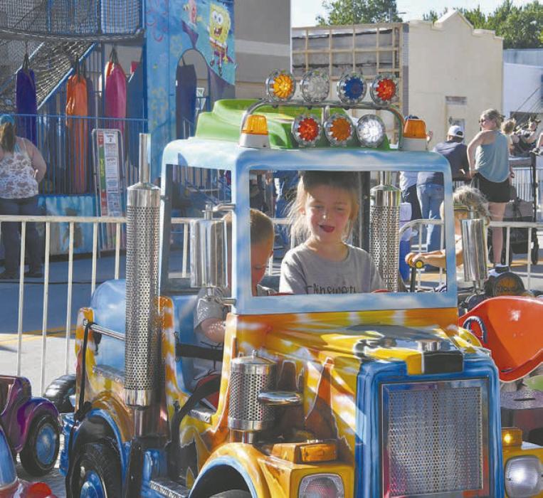 Vivian Kinzie enjoys a truck ride on the vehicle carousel.