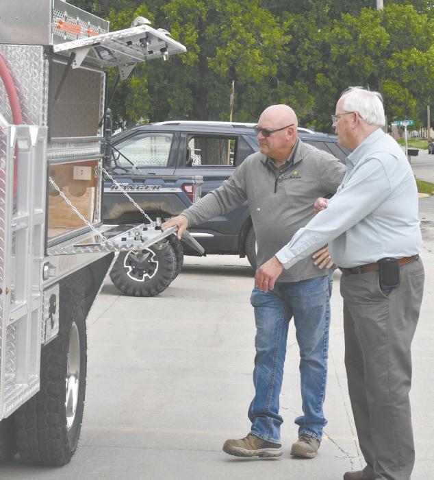 Ainsworth Fire Chief Brad Fiala (left) shows USDA Community Loan Specialist David Fulton some of the features of the new fire truck. Fulton said this project means a lot to him, as he has been a volunteer fireman for 30 years.