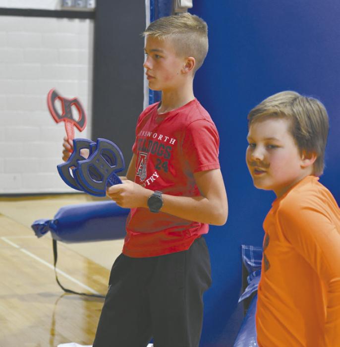 Blake Hansmeyer plays the axe throwing game.