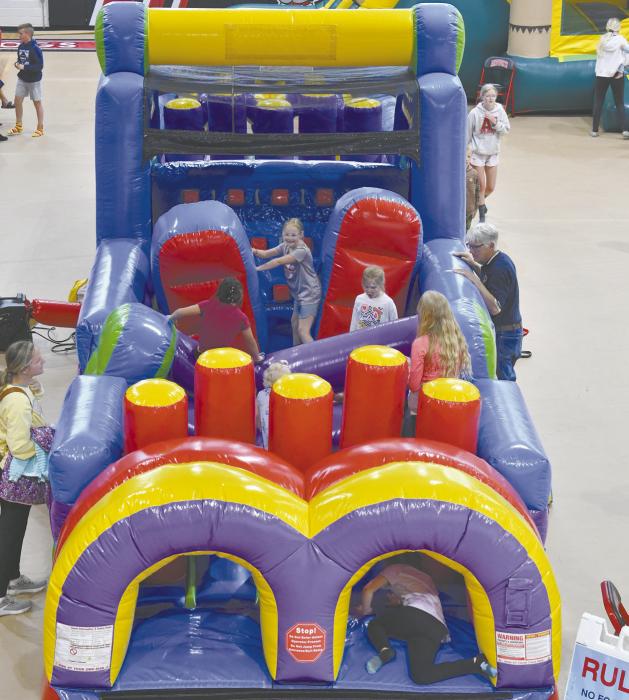 Due to inclement weather, the event was moved from the park into the ACS Gym. There were bounce houses and yard games to play.