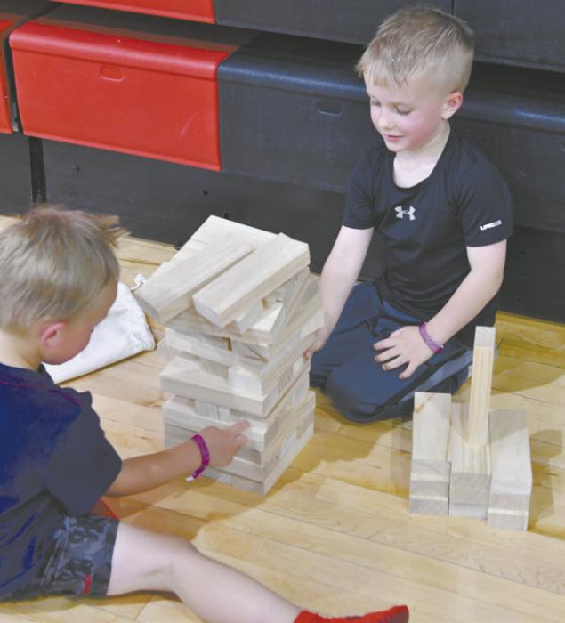 Brock Peterson and Miles Hansmeyer play giant jenga.