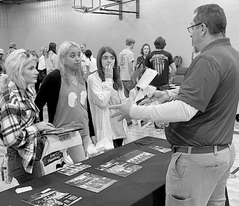 Three area students discuss financial aid options with the representative for the Army Nurse/Medical Corps.