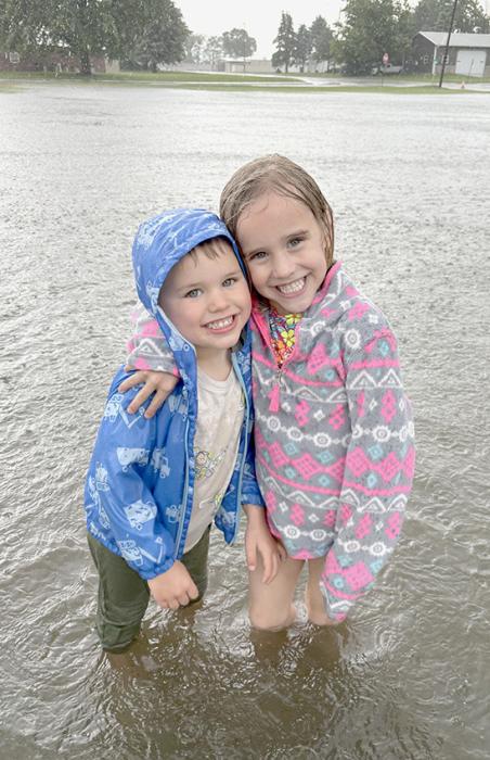 Karissa Beck (right) and Mackenzie Crane (left) went for a splash in the water that flooded Harrington Street on June 20th. Jameson and Parker Fairhead (pictured to right) enjoyed wading in the water that accumulated on St. Pius X’s lot south of the church.
