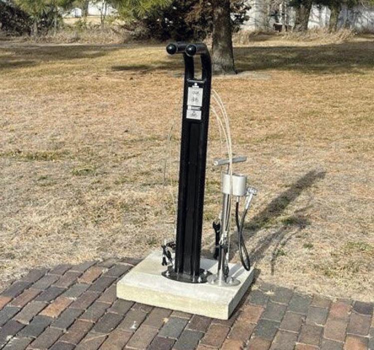 The repair stand is located on the Cowboy Trail in Long Pine. It provides nine standard bike repair tools as well as a hand air pump.