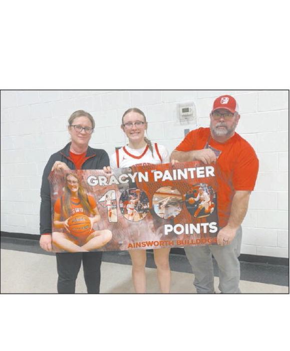 Ainsworth basketball junior Gracyn Painter reached a milestone of 1,000 points during the team’s game against Boyd County in the seventh-place matchup of the Niobrara Valley Conference Girls Basketball Tournament. She stands with her mother, Katie, and father, Clint.