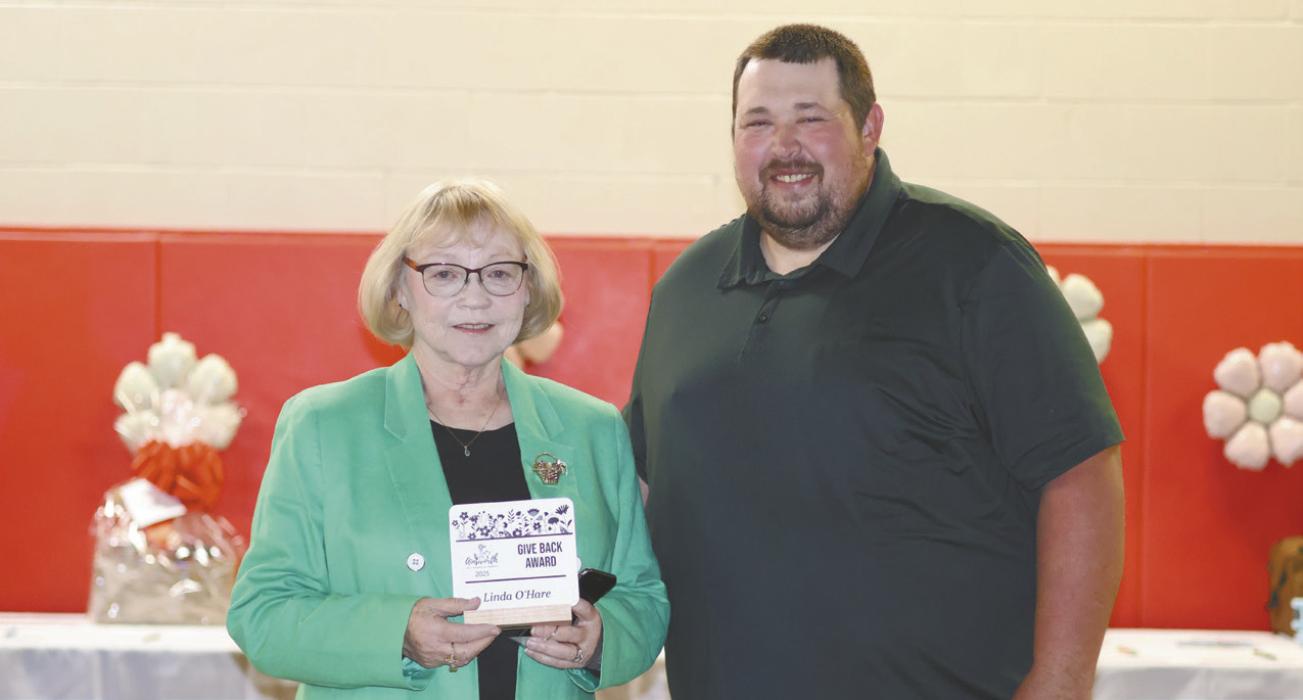 Linda O’Hare stands with Willy Kackmeister after being announced as the Community Give Back Award recipient.