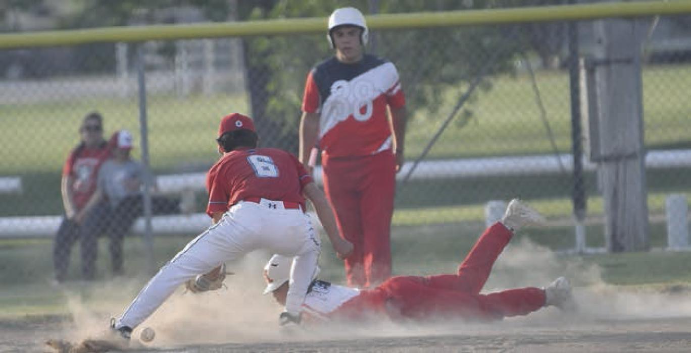 Nathan Fernau slides into home, stealing a base after a wild pitch during the Ponies game.