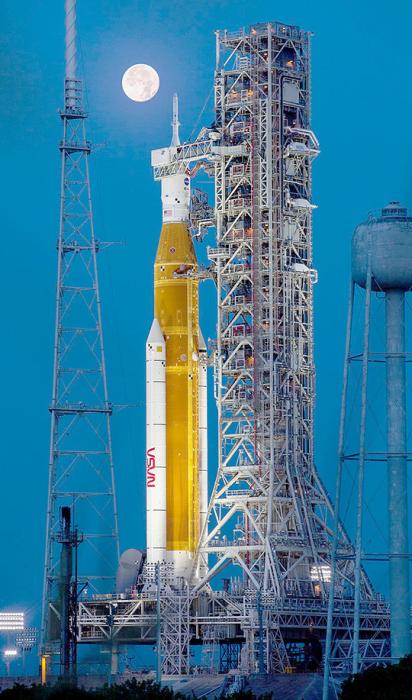 Full Moon over Artemis-1 on July 14, 2022, as the integrated Space Launch System and Orion spacecraft await testing. Photo credit: NASA/Cory Huston Source: https://www.nasa.gov/image-feature/a-full-moon-over-artemis/
