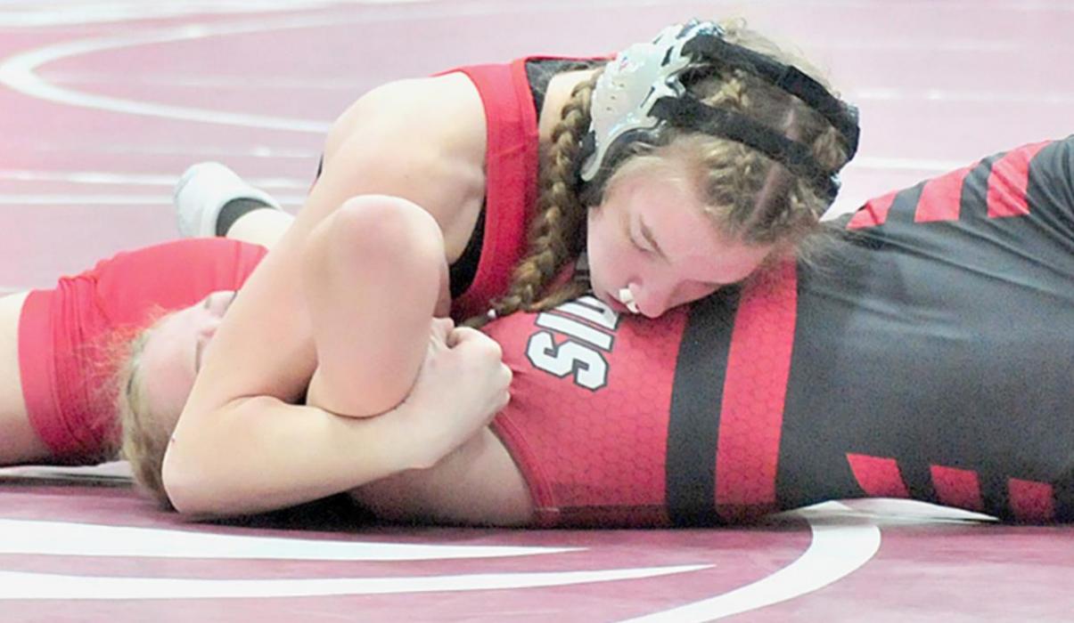 Pozehl holds down Ciena McKenzie of Sidney for her second pin of the district tournament.