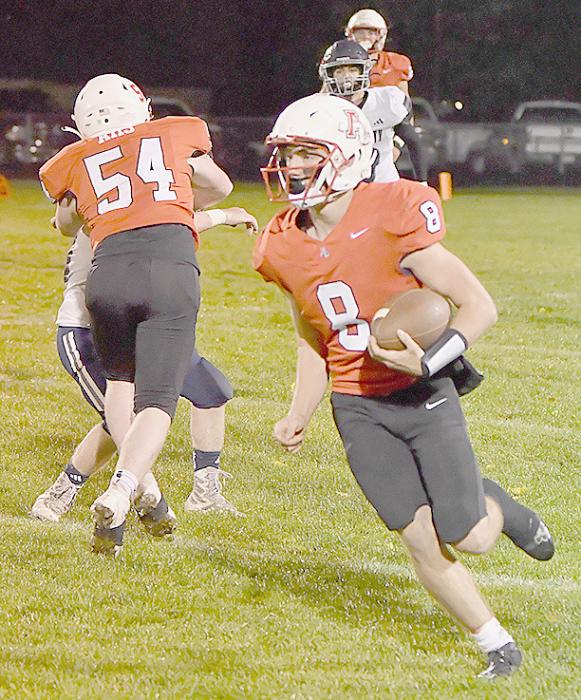 Witten Painter puts a block on a Boyd County defender to give Traegan McNally some running room.