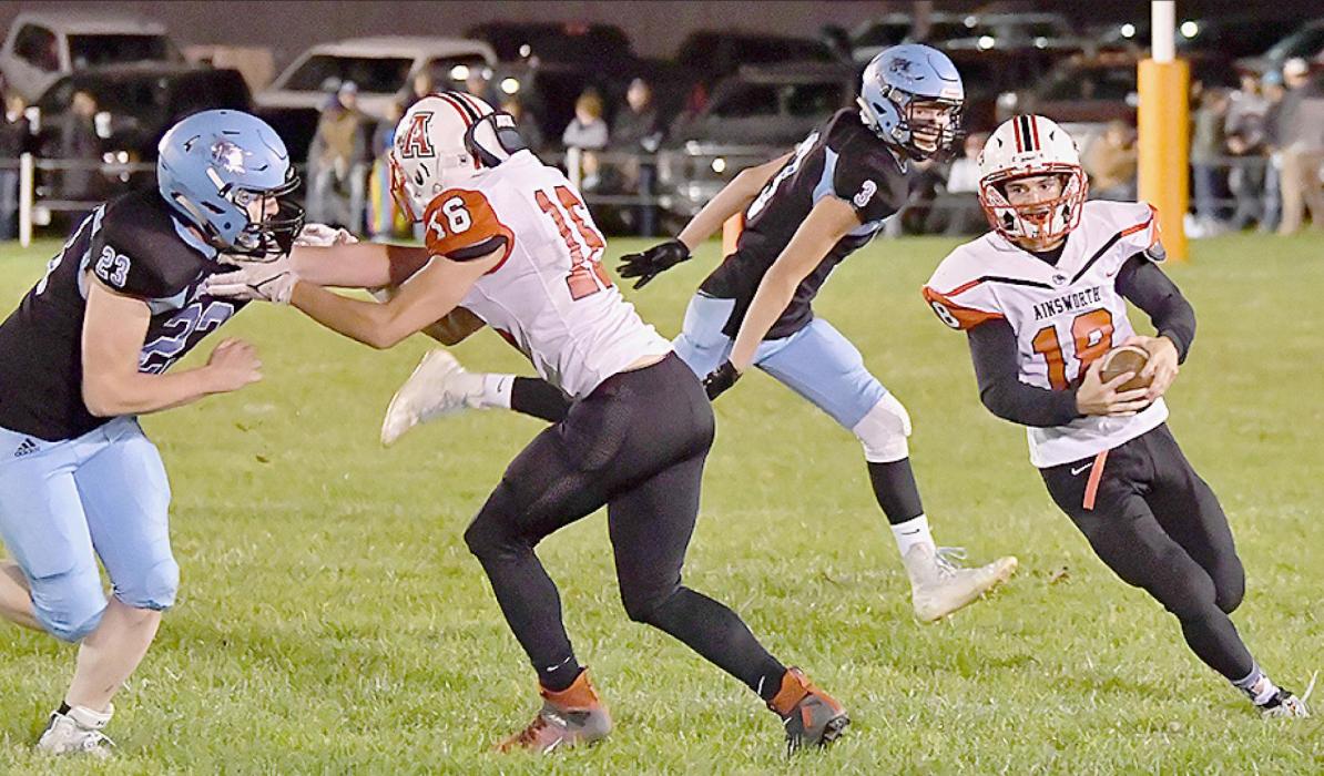 Senior Caleb Allen (#18) carried the ball 16 times for 116 yards against Summerland. Senior Cash Reynolds (#16) blocks for Allen in their final game in an Ainsworth uniform.