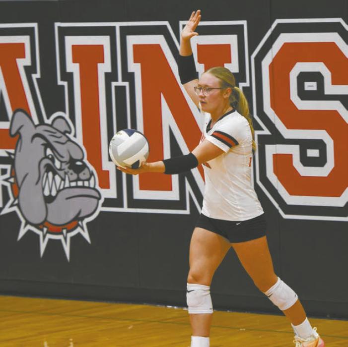 Senior Gracyn Painter prepares to serve the ball during the team's game against South Loup. Painter had two ace serves.