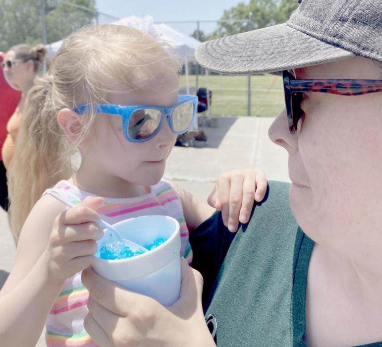 Enjoying an ice cold snow cone were mother and daughter, Janelle and Celia Carpenter.