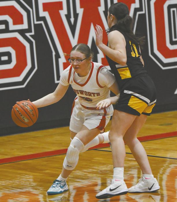 Gracyn Painter dribbles by Jenna Donohoe of Mullen after grabbing a rebound. Painter had 15 rebounds in the team’s game vs. Mullen.