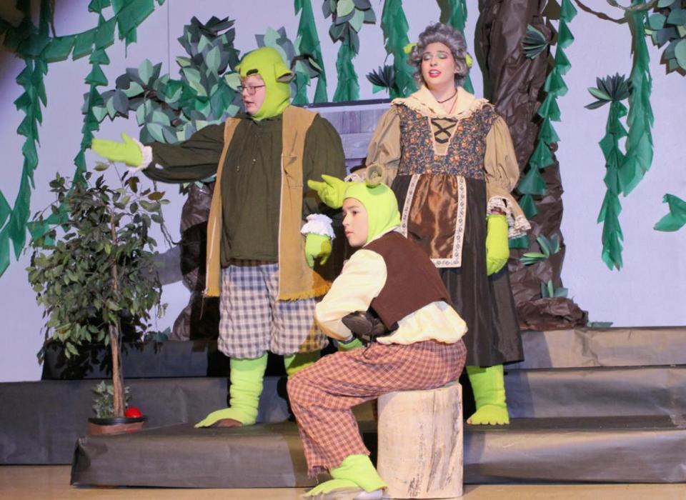 In the opening scene, Ian Finley (left) as Papa Ogre, Braeyden Ziemba (center) as Young Shrek and Jasmine Porter (right) as Mama Ogre perform a song together.