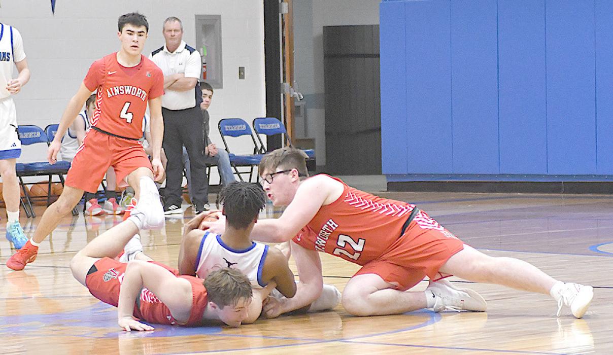 Witten Painter and Morgan Kinney dive to the floor in an attempt to recover a loose ball.