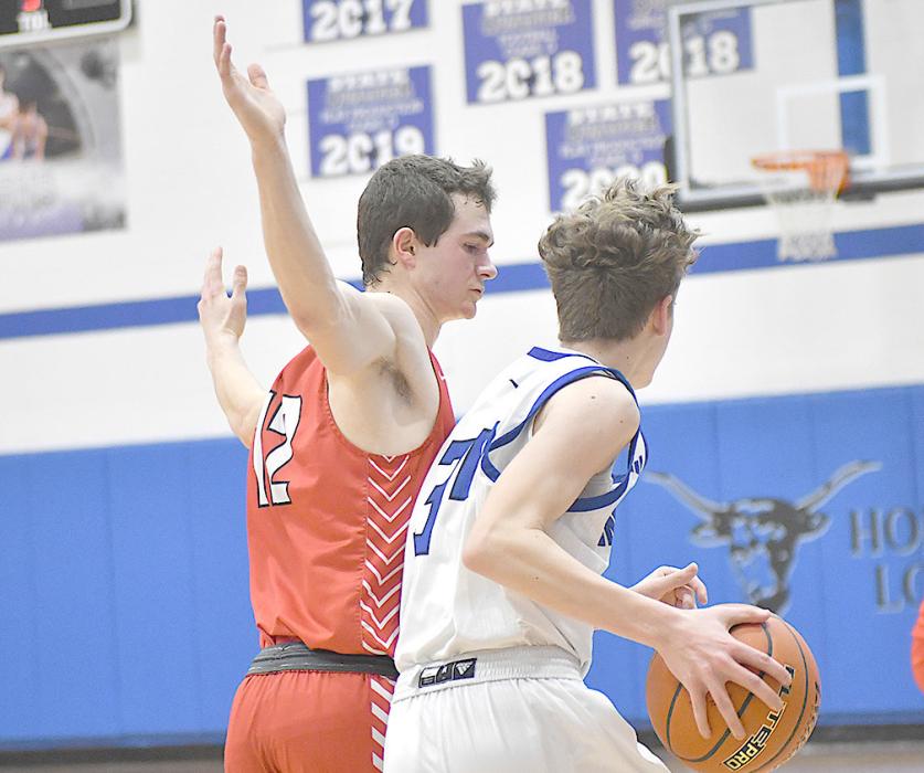 Schroedl tries to stop the ball as Hyannis’ Evan Merrihew drives down the court.