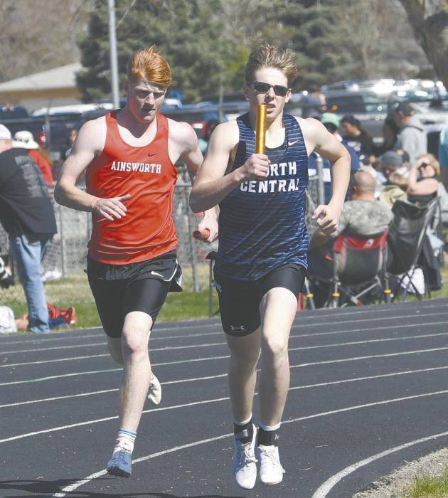 Sam Titus (left) works to pass the North Central 3200 meter relay team.