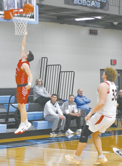 Ryan Salzman posts two for Ainsworth on a fast break against Winside in the Holiday Tournament.