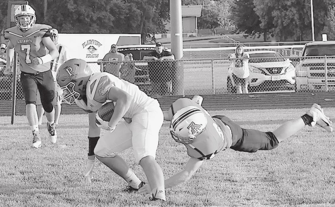 Freshman Jacob Held tackles Plainview’s Brendan Weber behind the line of scrimmage for a loss in Ainsworth’s opening game.
