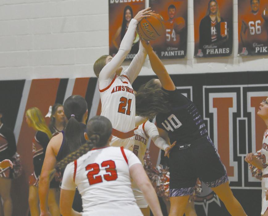 Jaylee Good (21) jumps for a rebound against a Burwell Longhorn. Good had nine rebounds during the game.