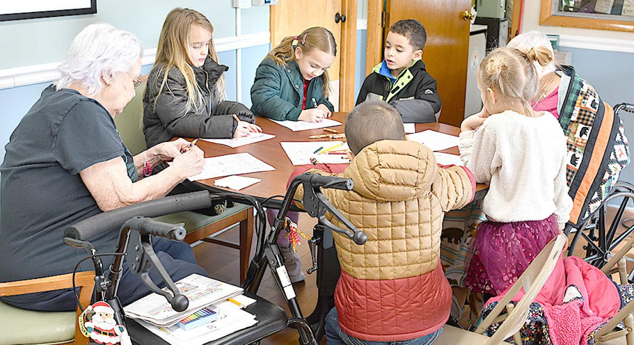 The Kindergarten class brought Valentine’s Day coloring sheets to decorate with the residents. Each of the grades were offered popcorn and a juice as a snack while they visited with the Care Center residents and staff.
