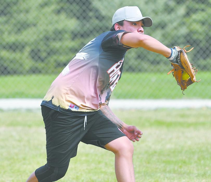 An outfielder from an out of town team makes a catch from a pop fly.