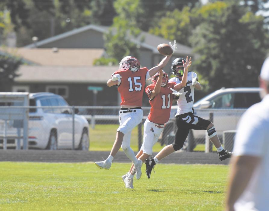 Jacob Ortner (15) and Bateson Raymond (11) attempt to intercept a pass meant for North Central's Brandt LeZotte (2).