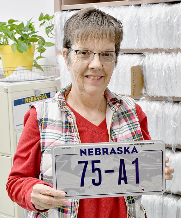 Brown County Treasurer Deb Vonheeder displays a new Nebraska license plate that will be issued starting in January, 2023.