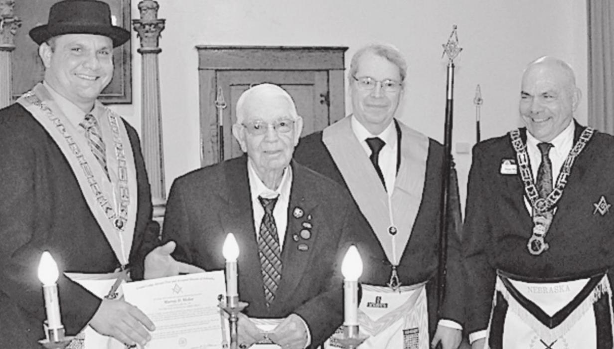 Worshipful Master Garrett Weidner (left), Grand Marshal of the Grand Lodge of Nebraska Stan Weidner (right) and Senior Deacon Phil Brown (second from right) made the 50 Year Pin presentation to Worshipful Brother Murray Mellor (second from left).