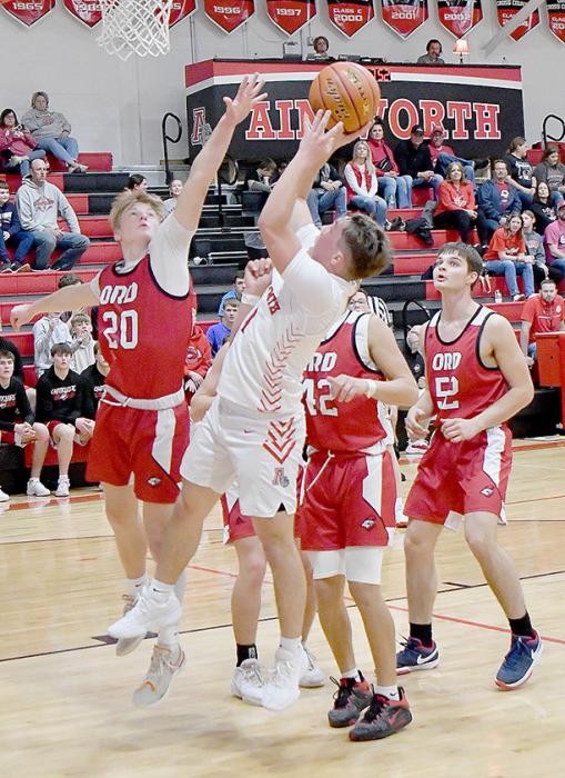 Morgan Kinney shoots a jump shot against four Ord defenders in the Bulldogs opening game of the 2024-25 season.