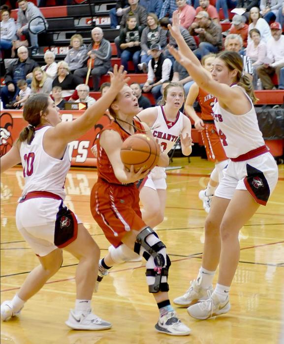 Kendyl Delimont drives between two Ord players and makes the basket for Ainsworth.