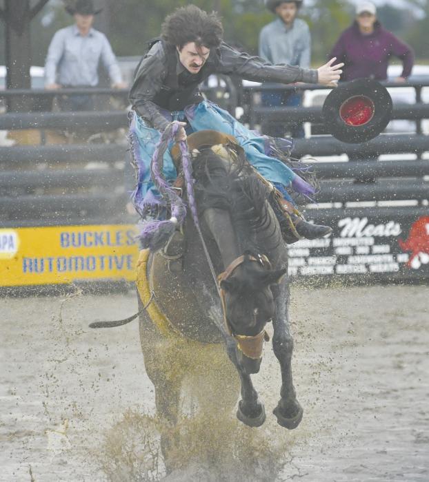 The Brown County Fair left many of its riders a muddy mess after falling from their roughstock. A bronc rider pictured above loses his hat during his ride.