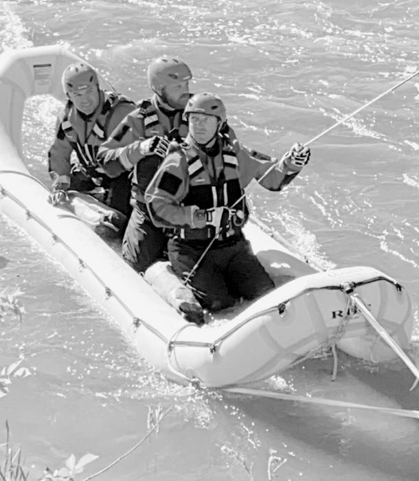 Lee Conroy, Drake Fiala and Trent Kinney practice with the inflatable rescue craft in the Niobrara River.