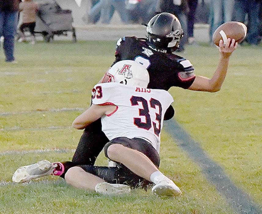 Aiden Jackman tackles North Central’s Quarterback Keian Fischer in the end zone for a safety midway through the first quarter.