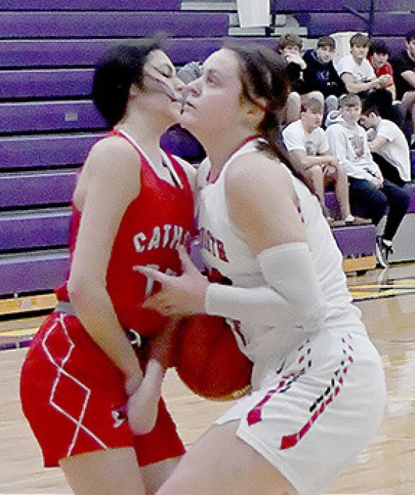 Driving for the basket, Karli Kral was fouled by Channatee Robies of Norfolk Catholic.