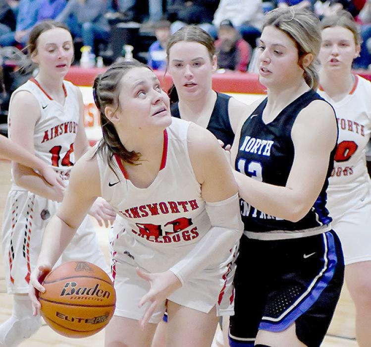 After getting one of her ten rebounds, Karli Kral looks to put the ball back up against the North Central Lady Knights.