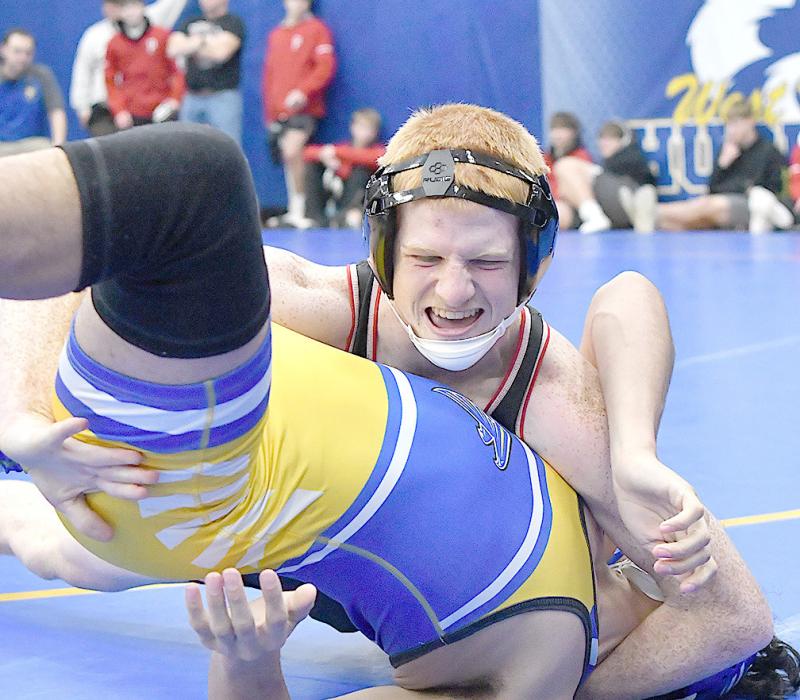 Junior Sam Titus gets near-fall points as he works his way to wining by technical fall against Todd County’s Devan White Feather.