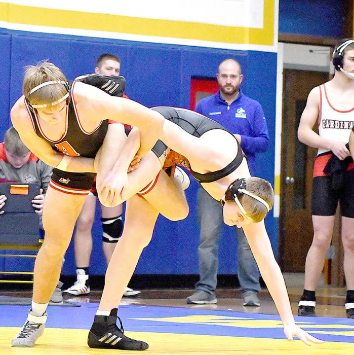 Senior Aiden Jackman works to take down Ben Johnson of Creighton. Jackman went 1-2 on the day.