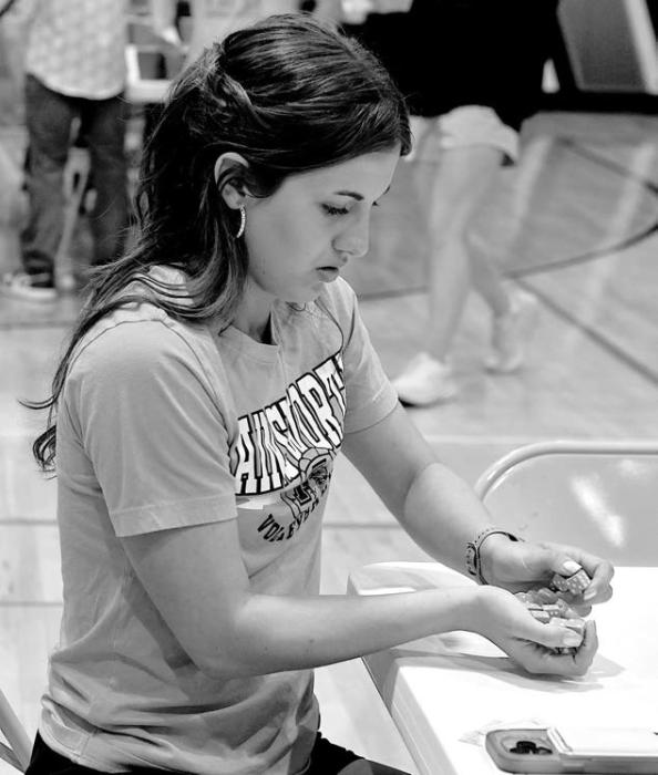 Sophomore prom server Willa Flynn plays the dice game Tenzii at post prom.