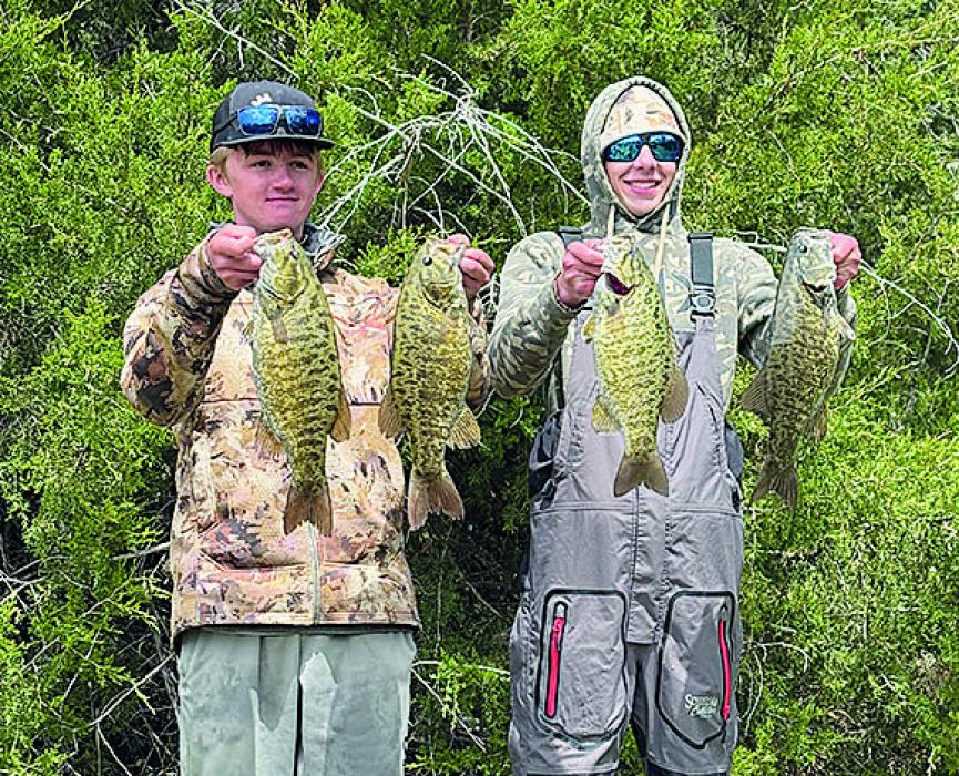 Teigan Marbry of Ainsworth (left) and Tayson Stiehl of Pierre, SD (left), hold four of their five bass after winning the fishing tournament.