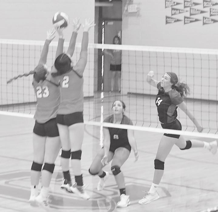 Elizabeth Wilkins (23) and Summer Richardson (2) put up a block against North Central’s Mackinzie Arnholt (8) and Allie Cosgrove (14).