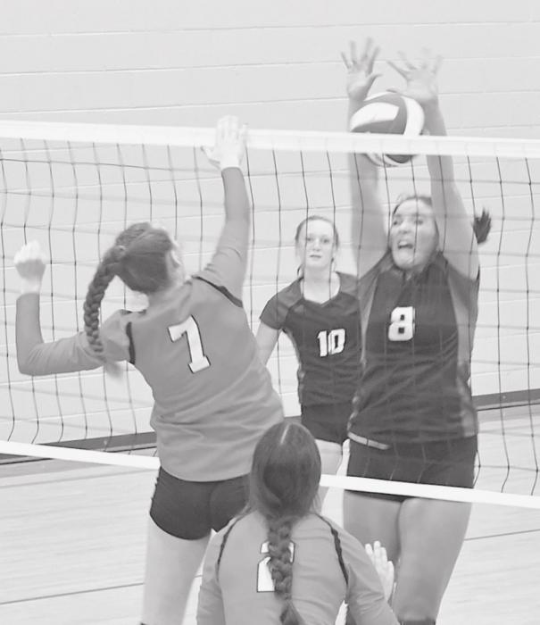 Above, Cameryn Goochey (7) swings for one of six kills during the North Central game.