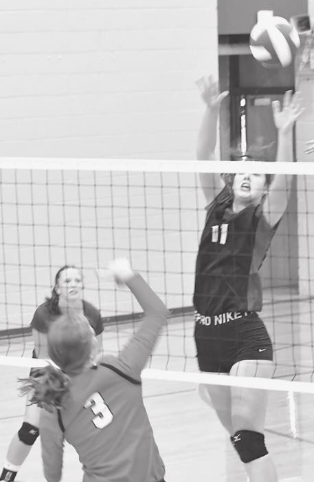 Right, Eden Raymond (3) hits the ball past the hands of a North Central blocker.